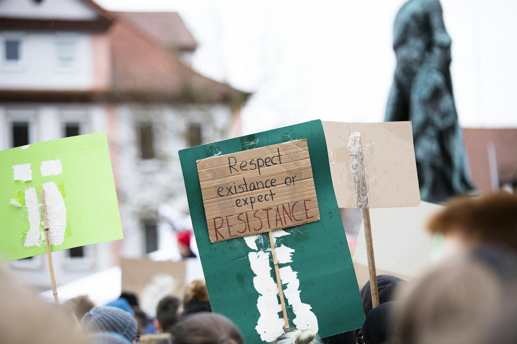Protestors march with handmade signs in Erlangen, Germany, advocating environmental change.